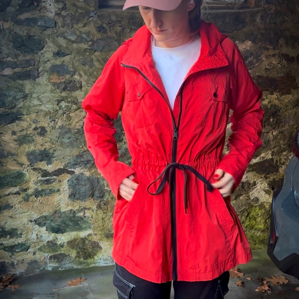 bright red raincoat with adjustable waist and hood
